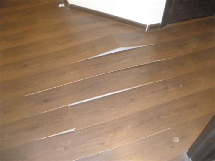 How do you fix a swollen laminate floor without replacing it?