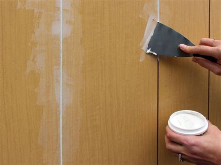 How do you paint over wall paneling?