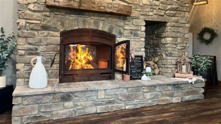 How far should the hearth of a wood burning fireplace project into a room?