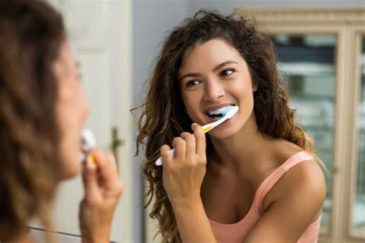 Should I brush my teeth before drinking water in the morning?