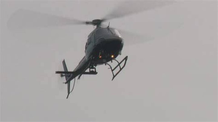 Why do helicopters circle around neighborhoods at night?